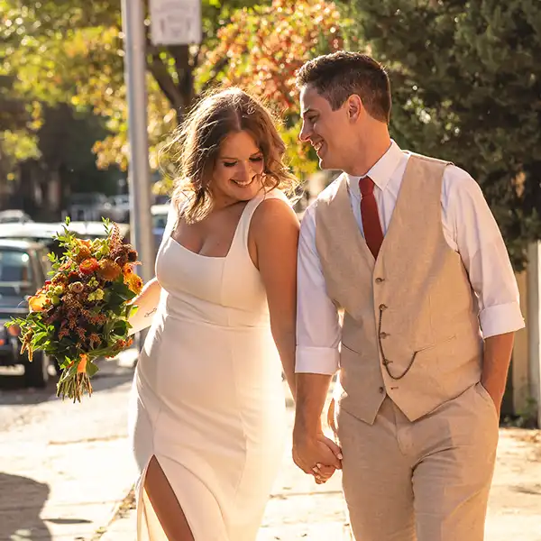 Couple holding hands on their wedding day in Baltimore